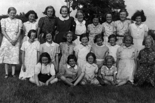 Evacuees from West Ham and Dagenham in Calais Field, Milton with Miss Clark. Mary Barnes 4th from left in back row. (1941)